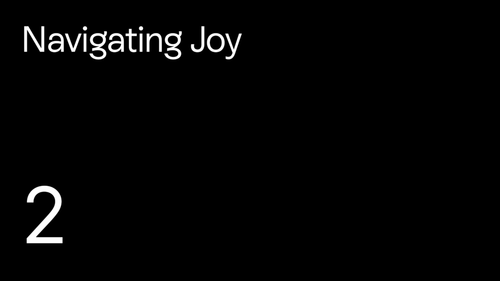 Black title slide reading "Navigating Joy" in white text, with a large white number 2 in the lower left.